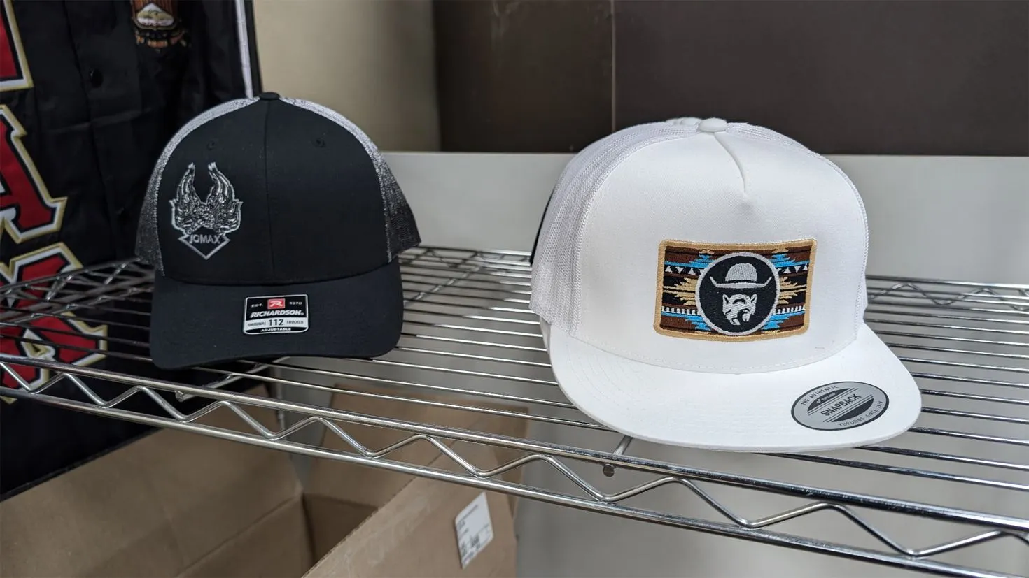 Embroidery machine stitching custom apparel in the studio